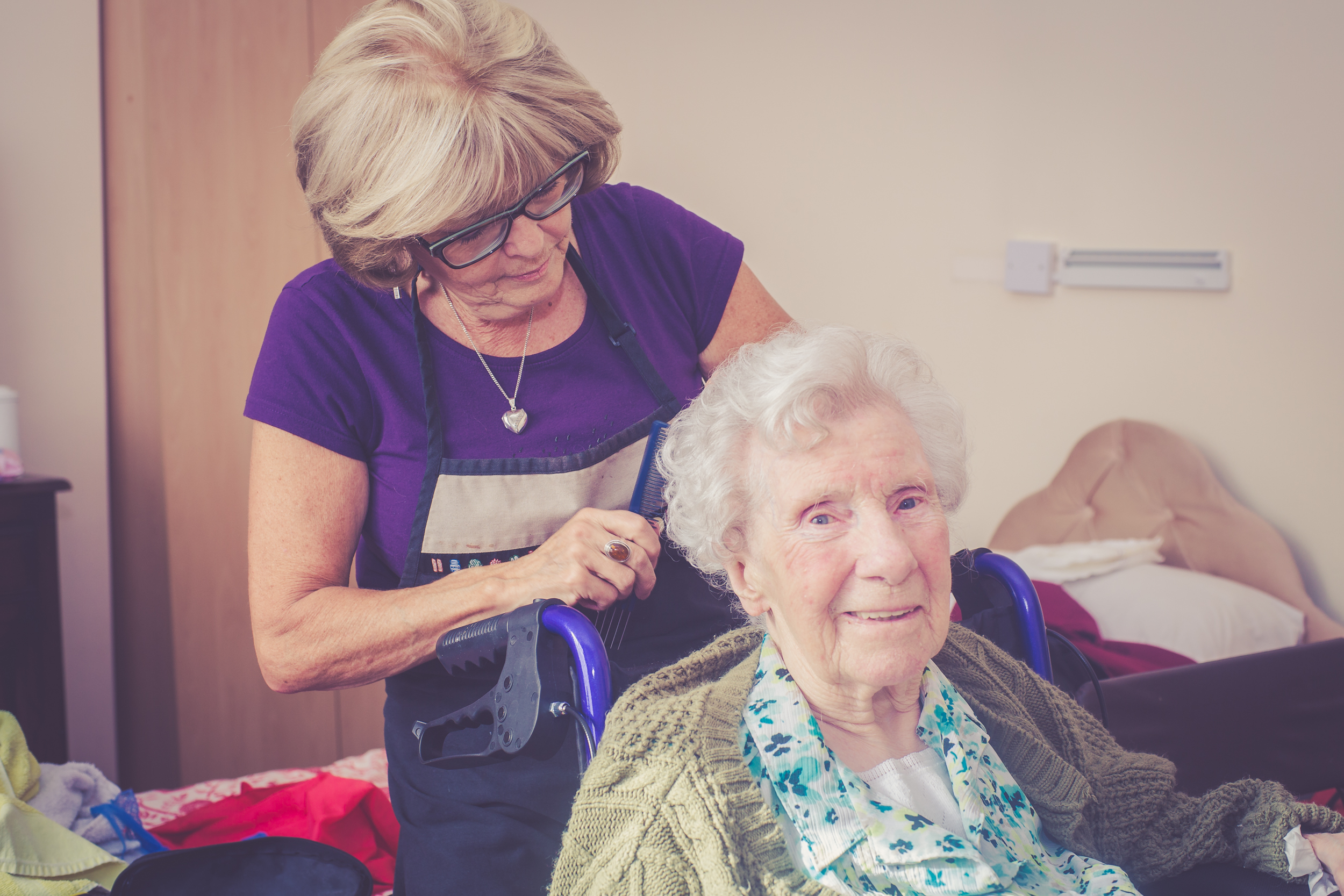 A carer brushing a resident's hair